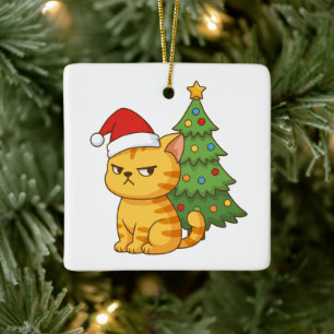 Mürrische orange getigerte Katze mit roter Weihnac Keramikornament