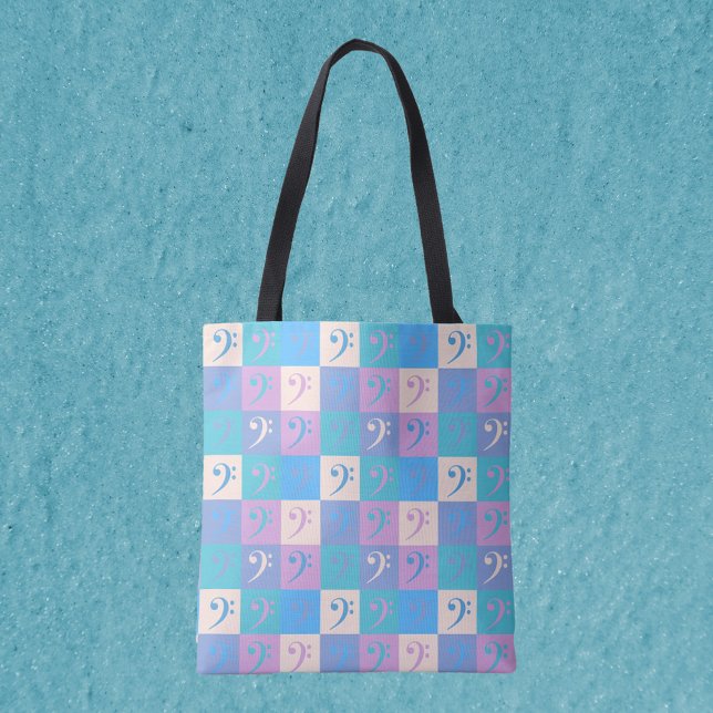 Music Bass Clef Pastel Pattern (An all over print tote bag featuring a pattern of bass clefs in yellow, pink, purple and blue.)