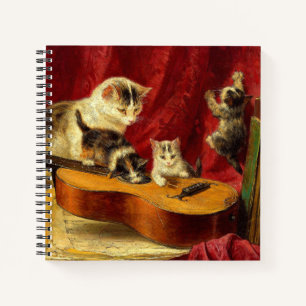 Mutter Katze und Kätzchen spielen mit Gitarre Notizbuch