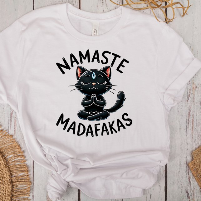 "Namaste Madafakas" Funny Cat Lovers Tri-Blend Shirt ("Namaste Madafakas" Funny Cat Lovers Tri-Blend Shirt on a desk with boho decoration)