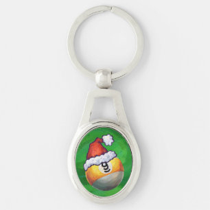 Neun Ball in Weihnachtsmannmütze über Grün Schlüsselanhänger