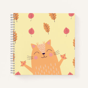 Niedliche orangefarbene Katze spielt im Herbstlaub Notizbuch