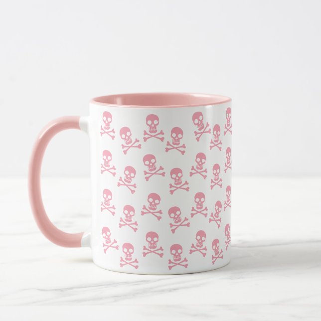 Niedliche rosa Tasse des Schädels und der Querknoc (Links)