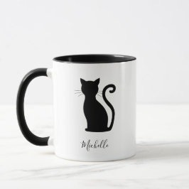 Niedliche schwarze Katze mit schwarzem und weißem Tasse