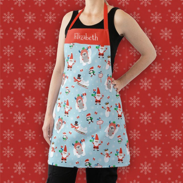 Niedliche Weihnachtsfeiertage Schürze (A fun winter Christmas holiday apron featuring Santa, a yeti, a snowman, and penguins)