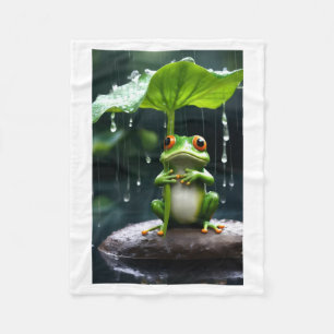 Niedlicher Frosch hält Blattregenschirm im Regen F Fleecedecke
