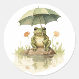 Niedlicher Frosch mit einem Regenschirm am See Runder Aufkleber