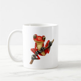 Niedlicher roter Baum-Frosch auf einer Kaffeetasse