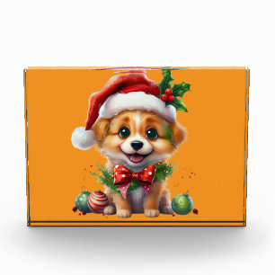 Niedlicher Weihnachtswelpen mit Weihnachtsmannmütz Fotoblock