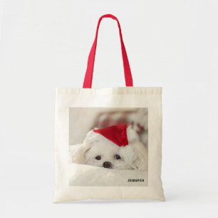 Niedlicher Weißhund in einem Red Christmas Hat Tragetasche