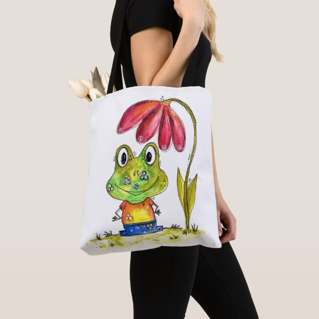 Niedlicher Whimsical Green Frosch unter einer rote (Von Nahem)