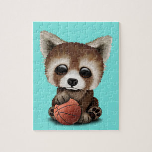 Niedliches Baby-roter Panda, der mit Basketball Puzzle