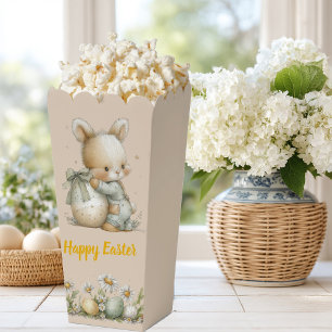 Niedliches Babykaninchen in Schlafanzug mit Ostere Geschenkschachtel