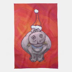 Niedliches Hippo in der Weihnachtsmannmütze über R Handtuch