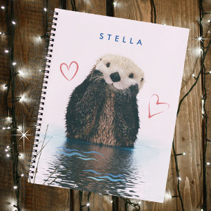 Niedliches Otter im Teich mit rosa Hintergrund und Notizbuch