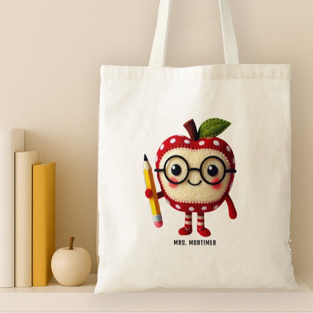 Niedliches rotes Apfelzeichen mit dem Namen des Bl Tragetasche (tote back for teachers with a cute apple man character holding a pencil. Add a name)