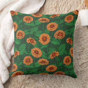 Orange Zinnia Blume, grüne Blätter auf dunkelgrün Kissen
