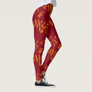 Orangefarbene Blätter der Silhouette auf rot Leggings