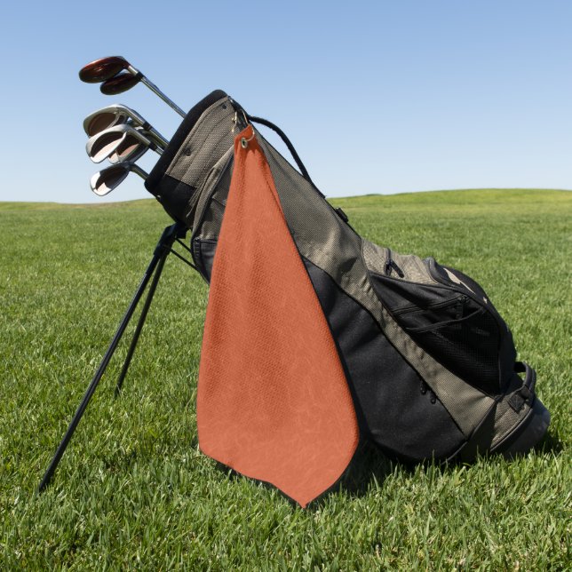 Orangefarbene texturierte Oberfläche mit wirbelnde Golfhandtuch (Gras)