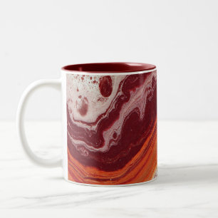 orangefarbene und burgunderrote Flüssigkeit Zweifarbige Tasse