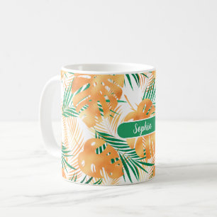 Orangefarbene und grüne tropische Blätter, weißer Kaffeetasse