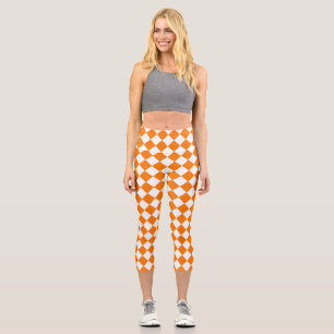 Orangefarbenes weißes Schachbrett Diamantmuster Capri Leggings