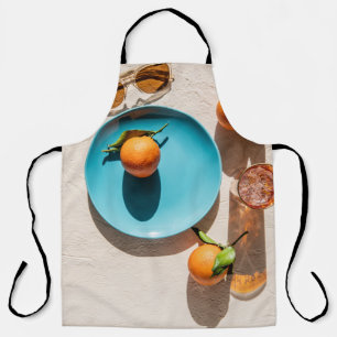 Orangenfrüchte auf Platte Schürze