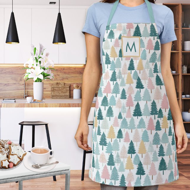 Pastel Christmas Pine Trees Mit Monogramm Kitchen Schürze (A monogrammed kitchen apron with festive Christmas trees pattern in teal, pink, yellow and white)