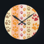 Paw Prints niedlich Hunde Liebhaber Runde Wanduhr<br><div class="desc">Design mit einem niedlichen Muster von Hundepfoten in Orange und Gelb und warmen Farben. Dieses Design sieht so aus,  als ob ein Hund über das Produkt gegangen ist! Für Hundefreunde überall.</div>