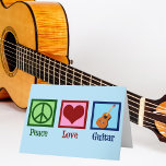 Peace Liebe Guitar Feiertagskarte<br><div class="desc">Eine coole Gitarrist Weihnachtskarte mit einem Friedenszeichen,  Herz und Gitarre auf einem wunderschönen blauen Hintergrund. Eine niedliche Musikinstrument speichern Urlaubskarte,  die Peace Liebe Guitar liest.</div>