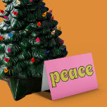 Peace Retro Pink and Lime Green Feiertagskarte<br><div class="desc">This retro style card features the message "Peace" on the front in lime green letters against a pink background. The inside message can be customized with your own greeting.</div>