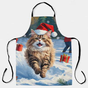 Persische Katze sitzt im Schnee mit Weihnachtshut Schürze