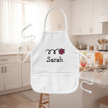 Personalisierte Backform Schürze für Kinder<br><div class="desc">Schürze zum personalisierten Kochen / Backen für Kinder | Weiß. Kleine, rosa Blume Schürze mit individuelle Name für kleinen Koch. Niedliche Designs für Jungen und Mädchen. Spaß Geschenkidee für Geburtstagsparty.</div>