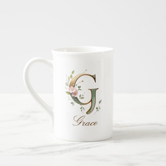 Personalisierte goldene Blumenmonogramm-Initiale G Prozellantasse (Links)