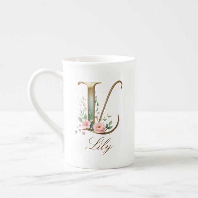 Personalisierte goldene Blumenmonogramm-Initiale L Prozellantasse (Links)