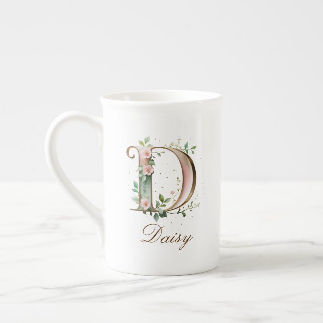 Personalisierter goldener Blumenmonogramm-Initiale Prozellantasse (Links)
