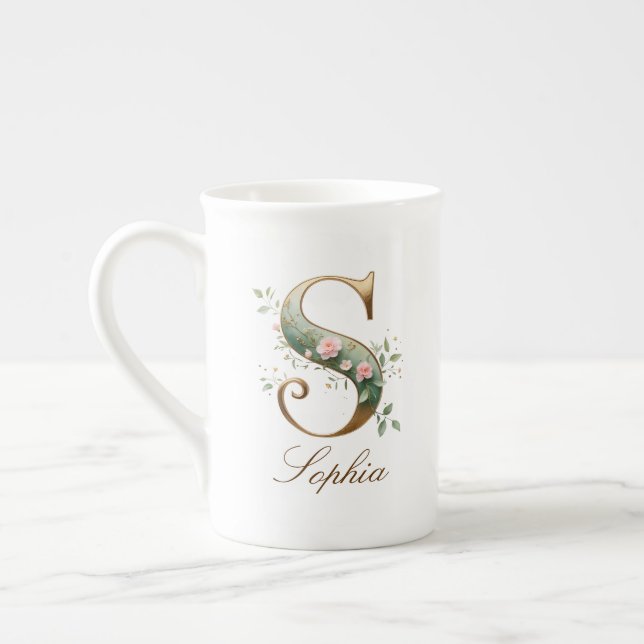Personalisierter goldener Blumenmonogramm-Initiale Prozellantasse (Links)