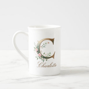 Personalisierter goldener Blumenmonogramm-Initiale Prozellantasse