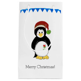 Pinguin in einer Weihnachtsmannmütze Kleine Geschenktüte