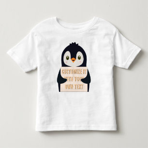 Pinguin-Maskottchen hält ein Schild für benutzerde Kleinkind T-shirt