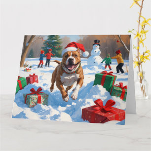 Pitbull-Hund läuft im Schnee mit Weihnachtsmütze Karte