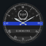 Police Styled American Flag Badge and Name Große Wanduhr<br><div class="desc">An der Wall clock featuring a blue line American flag symbollic of law-enforcement.  Roman numerals and a spot for yours or your gift recipient badge number and last name.</div>