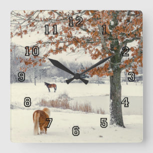 Pony and horse in snow by a lake clock quadratische wanduhr