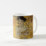 Portrait von Adele Bloch-Bauer I von Gustav Klimt Kaffeetasse<br><div class="desc">Das Portrait von Adele Bloch-Bauer I (1903-1907) von Gustav Klimt ist ein Vintages Viktorianisches Zeitalter-Symbolismus Kunstporträt. Portrait von Adele Bloch-Bauer I. ist auch bekannt als die Dame in Gold oder die Frau in Gold. Das Portrait zeigt Adele Bloch-Bauer, der auf einem goldenen Stuhl vor einem goldenen Sternenhimmel sitzt. Sie trägt...</div>