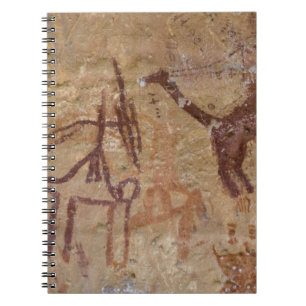 Prähistorische Felsgemälde mit Kamelen und Notizblock