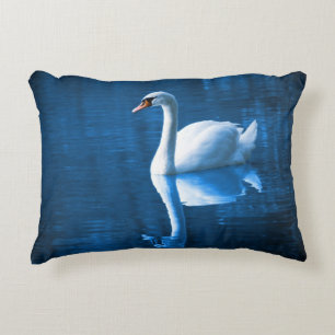 Pretty white swan floating on blue lake zierkissen