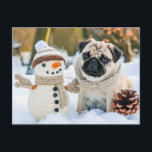 Pug Sitting Next to Snowman in Winter Postkarte<br><div class="desc">pug sitting beside a snowman in a winter setting,  capturing playful interaction in the snow.</div>