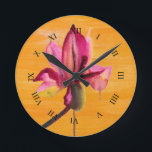 Purple Orchid watercolour orange pop art flower Runde Wanduhr<br><div class="desc">From original watercolour painting by Sacha Grossel of a purple watercolour flower design on bright orange pop art vidly coloured painted art background. Vibrierende Designs was inspiriert von tropischen Flora Climates and is a botanical meets pop art style.</div>