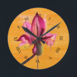 Purple Orchid watercolour orange pop art flower Runde Wanduhr<br><div class="desc">From original watercolour painting by Sacha Grossel of a purple watercolour flower design on bright orange pop art vidly coloured painted art background. Vibrierende Designs was inspiriert von tropischen Flora Climates and is a botanical meets pop art style.</div>
