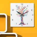 Rainbow Tree Square Wall Clock Quadratische Wanduhr<br><div class="desc">Diese whimsical Uhr ist mit einem Ausdruck eines Baumes des Lebens in Regenbogenfarben dekoriert. Der Baum wurde ursprünglich aus Mosaik mit winzigen Fragmenten aus Glas in lebhaften Farben hergestellt. Weil wir unsere eigenen Kunstwerke erstellen,  werden Sie dieses exakte Bild von anderen Designern nicht finden. Original Mosaik © Michele Davies.</div>